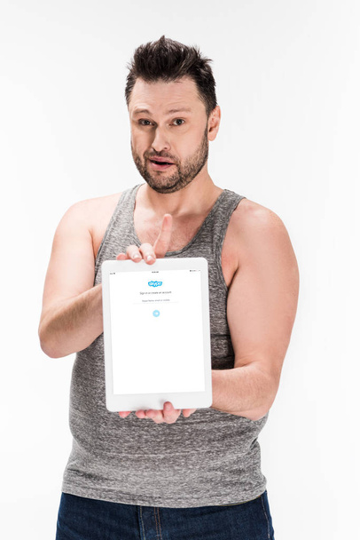overweight man looking at camera and showing digital tablet with skype app on screen isolated on white - Photo, Image