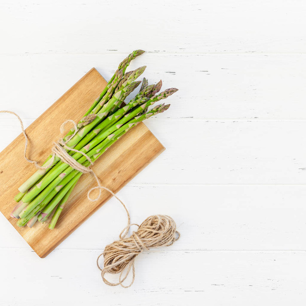 Fresh green asparagus on white wooden background - Fotografie, Obrázek