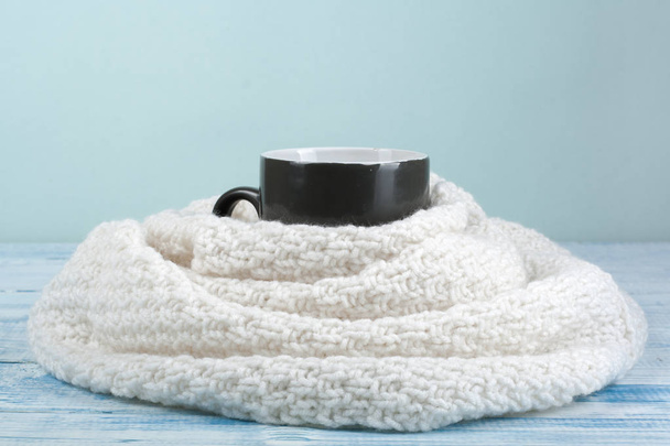Top view image of white cozy knitted sweater with to cup of coffee on a wooden table - Foto, Bild