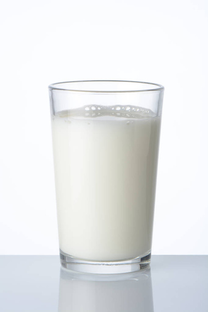 Glass with milk on white background - Valokuva, kuva