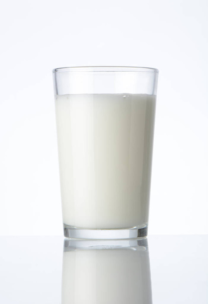 Glass with milk on white background - Фото, зображення