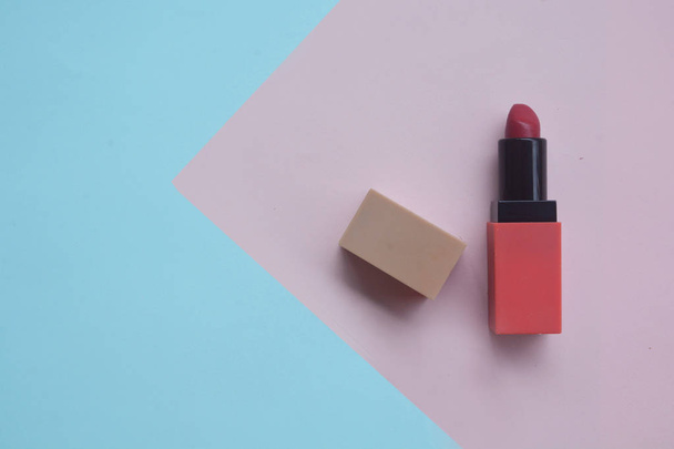 Red lipstick isolated on pastel background, Minimal makeup fashi - Фото, изображение