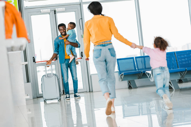 selective focus of happy african american family meeting in airport - Photo, Image
