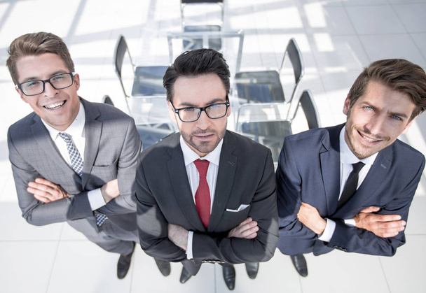 three confident businessman on background of office - Photo, image