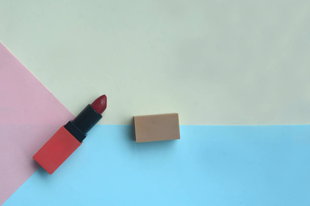 Red lipstick isolated on pastel background, Minimal makeup fashi - Foto, imagen