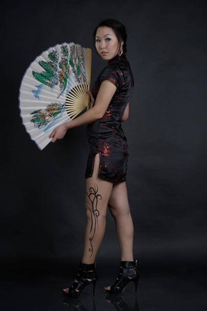 Asian woman with fake drawing tattoo on her leg - Photo, image