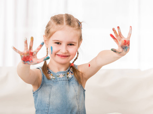 Girl showing her painted palms - Фото, изображение