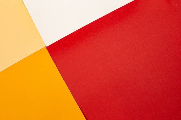 sheets of colored paper. Many colored sheets of paper are laid out in the harsh composition. background of colored paper. warm colors - Foto, imagen