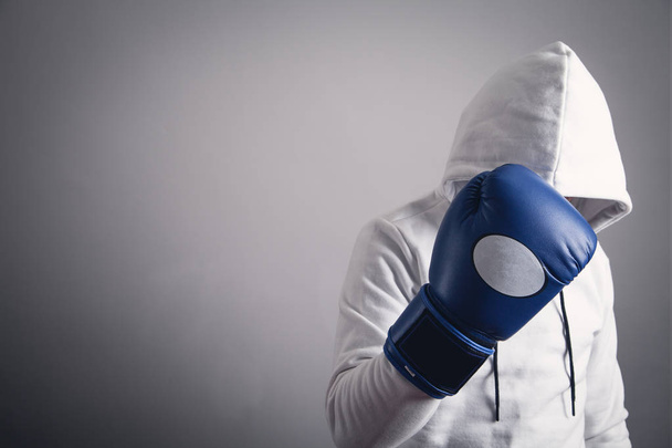 Hooded man with a boxing gloves. - Fotoğraf, Görsel