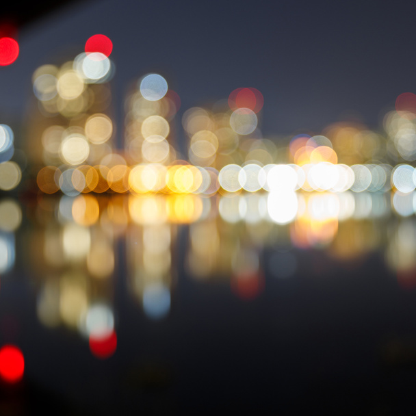 blurred illuminated buildings, reflection and bokeh lights - Foto, Imagem