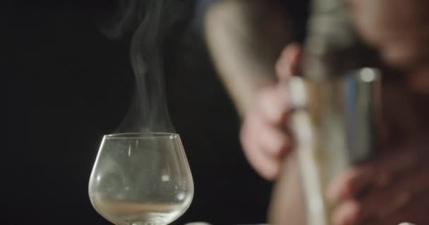 bartender is pouring his drink into smokey glass - Footage, Video