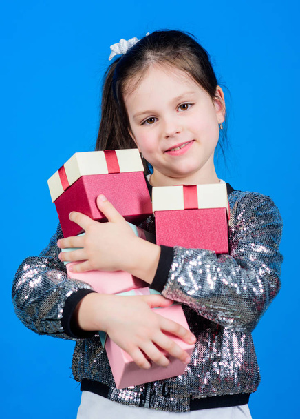 Shop for what you want. Girl with gift boxes blue background. Black friday. Shopping day. Child carry lot gift boxes. Kids fashion. Surprise gift box. Birthday wish list. Special happens every day - Фото, зображення