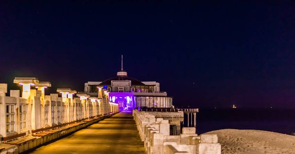 on the pier of Blankenberge beach, Belgium, Popular city architecture lighted by night - Photo, Image