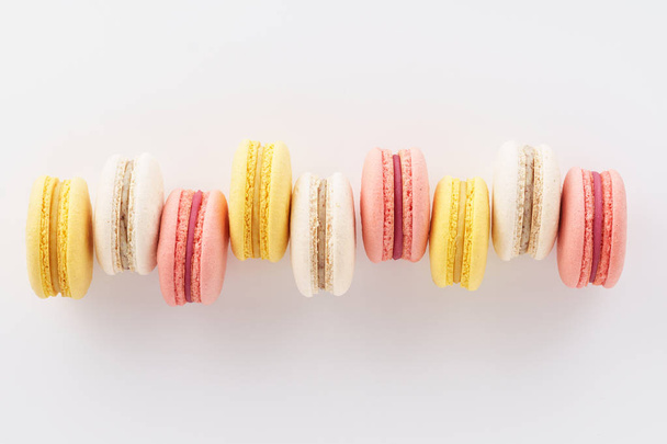 Row of colorful macarons on white background. - Valokuva, kuva