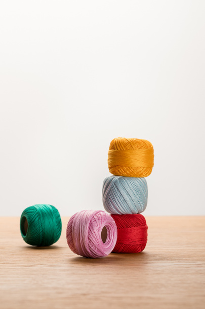 colorful knitting yarn balls on wooden table isolated on white with copy space - Photo, image