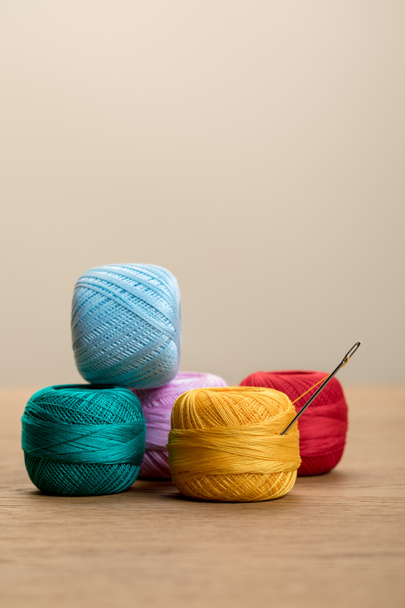 colorful cotton knitting yarn balls on wooden table isolated on beige with copy space - Foto, afbeelding
