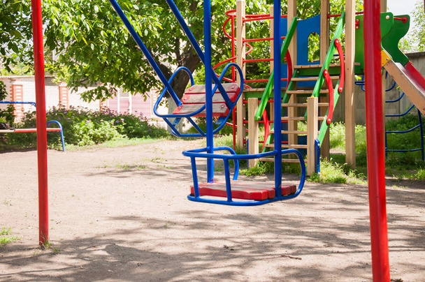 Swing, playground. Empty playground. Children swing without children - Photo, Image