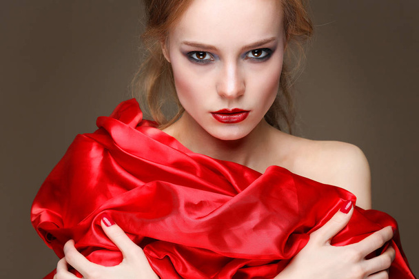 Closeup portrait of sexy young woman with beautiful red lips in red clothes - Fotografie, Obrázek