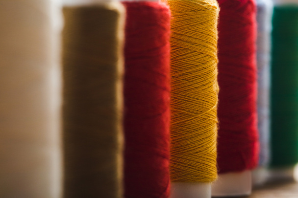 close up view of colorful cotton thread coils in row - 写真・画像