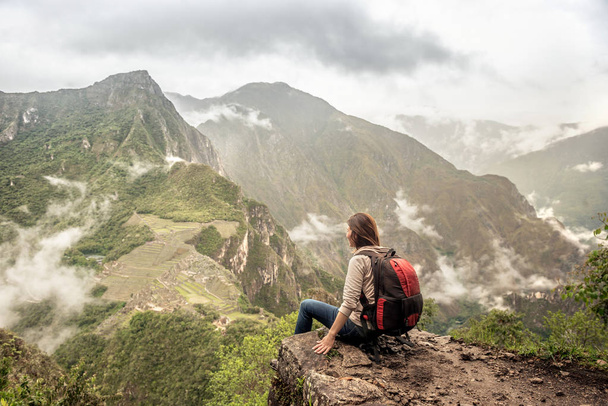 Girl-hiker looking on top of Huayna Picchu, looking on Machu Picchu - Фото, зображення