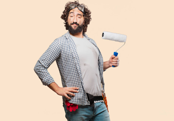 househusband handyman with a paint roller - Foto, afbeelding