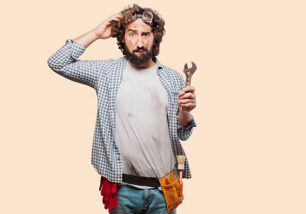 Adult househusband handyman with a wrench - Foto, afbeelding