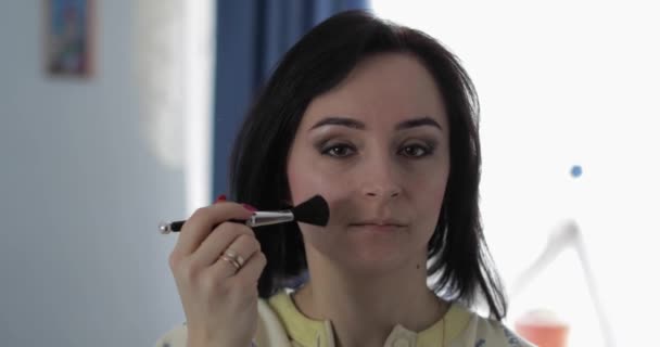 Young, pretty woman in pajamas near mirror. Beauty and makeup concept - Filmati, video