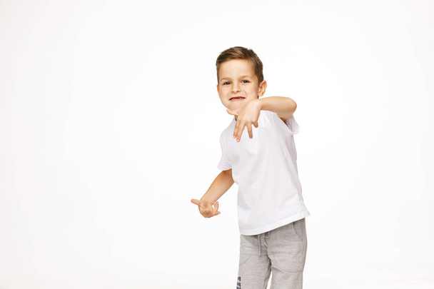 beautiful boy is dancing on a white background  - Foto, Imagen