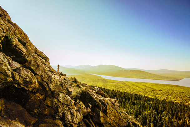 Hiker woman standing.  Successful woman hikeron sunrise mountain top. Girl in the mountains. - Foto, afbeelding