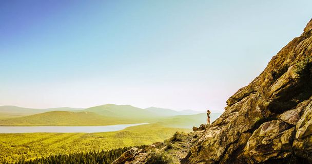 Hiker woman standing.  Successful woman hikeron sunrise mountain top. Girl in the mountains. - Fotoğraf, Görsel