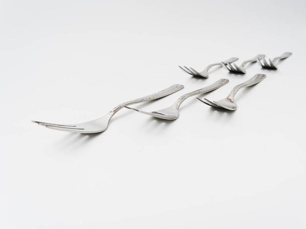 cutlery forks and spoons on a white background - Fotó, kép