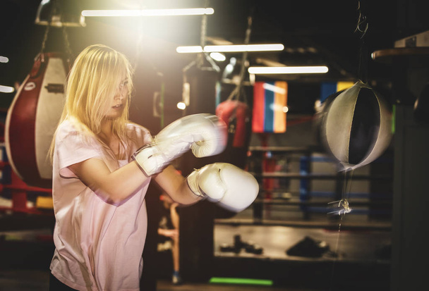 Boxer woman training at the punching ball - Фото, изображение