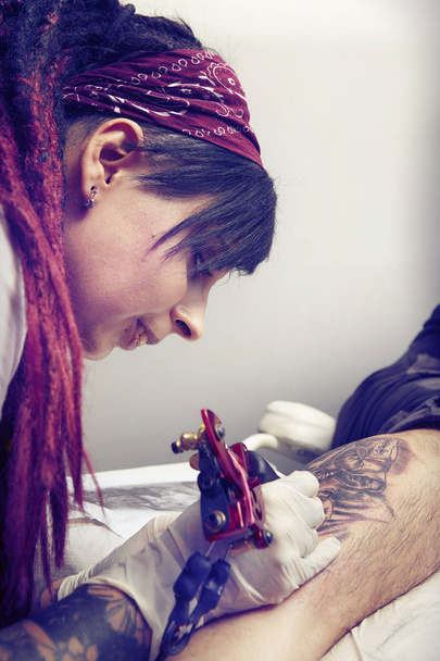 Session of tattooing in studio during making picture on calf - Фото, изображение