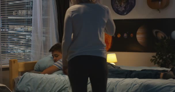 Son and mother together at bedside - Felvétel, videó