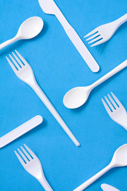 Disposable plastic tableware pattern on blue background - Φωτογραφία, εικόνα