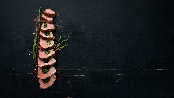 Beef steak with spinach on Wooden background. Top view. Free copy space. - 写真・画像