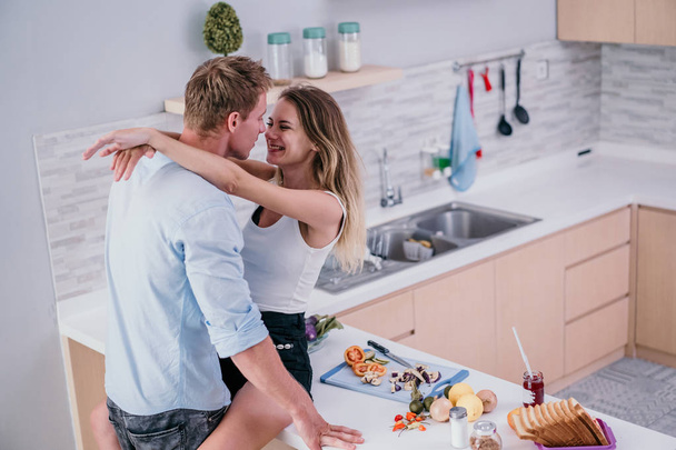 Young romantic couple on modern kitchen - Φωτογραφία, εικόνα