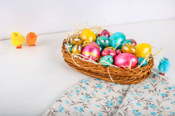 Easter eggs in basket on wooden background. - Φωτογραφία, εικόνα