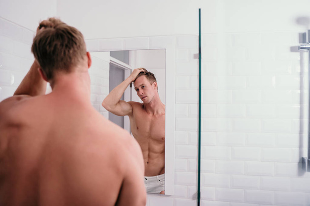 Portrait man muscle body at front reflection in the mirror - Фото, изображение