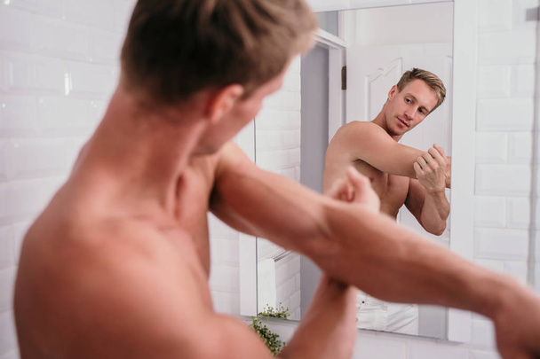 Handsome athletic men shirtless at front reflection the mirror - 写真・画像