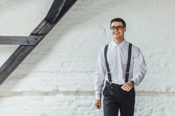 young businessman standing in modern office interior - Foto, imagen