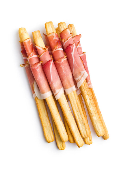 Parma ham prosciutto with grissini breadsticks. - Фото, изображение