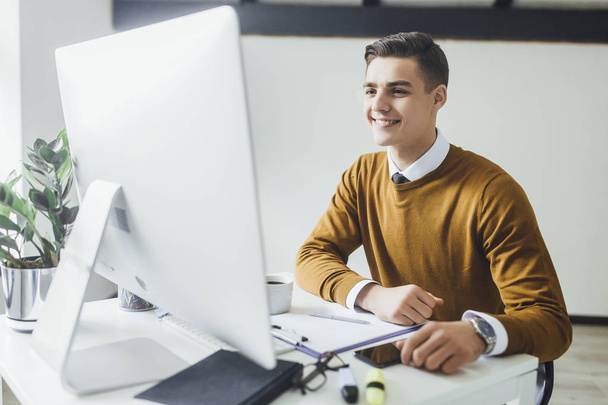 Brunette businessman in yellow sweater working at office, selective focus - Foto, Bild