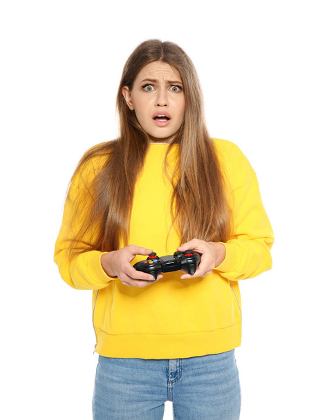 Emotional young woman playing video games with controller isolated on white - Fotografie, Obrázek