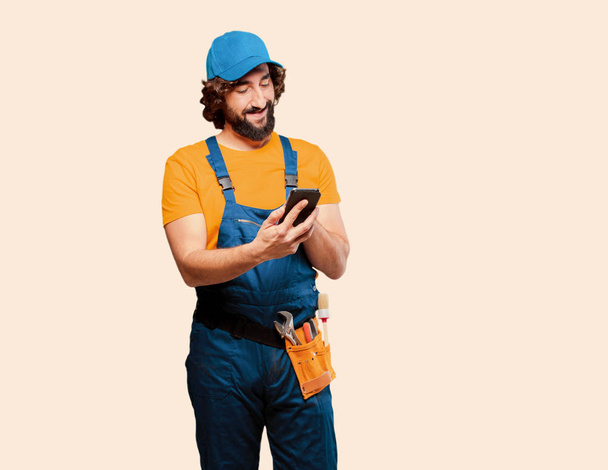 Adult handyman worker with a smartphone - Zdjęcie, obraz