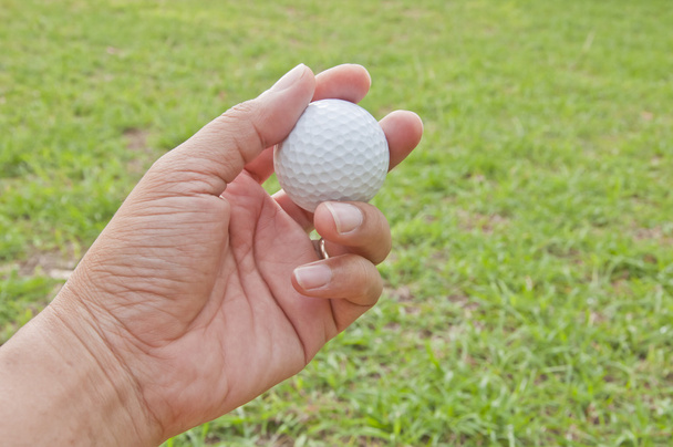 az ember kezét tartsa fehér golf labda - Fotó, kép