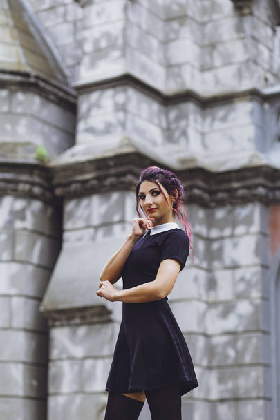 Young brunette girl in gothic style on a background architecture - Foto, immagini
