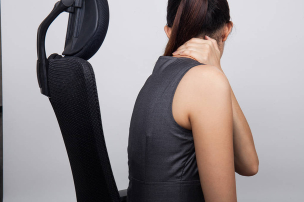 Businesswoman having pain in her neck,Neck pain at work - Photo, Image