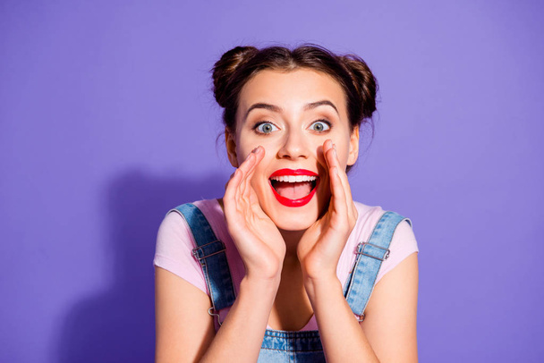 Close up photo beautiful amazing she her lady two buns perfect white teeth hands arms near mouth yelling loudly news wear casual t-shirt jeans denim overalls clothes isolated purple violet background - Foto, immagini