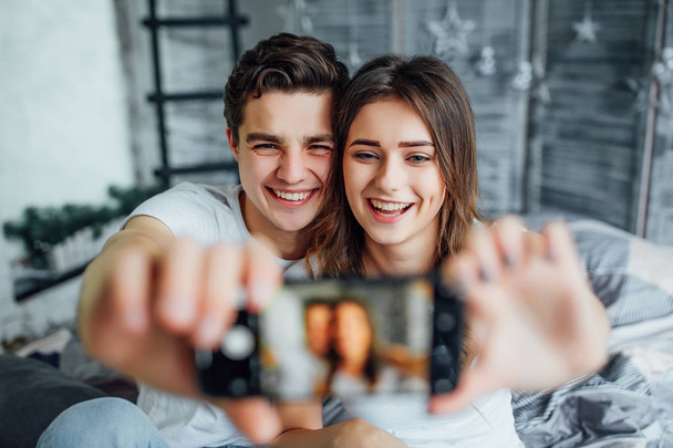 Happy couple making selfie in bedroom, selective focus - Valokuva, kuva